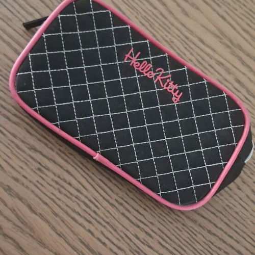 Hello Kitty pouch with pink details and checkered pattern