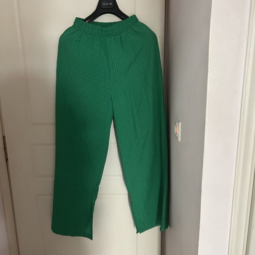 Emerald green two-piece set with cropped blouse and wide-leg pants
