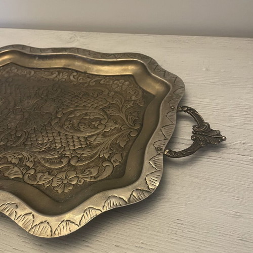 Vintage metal serving tray used with embossed floral and geometric carvings