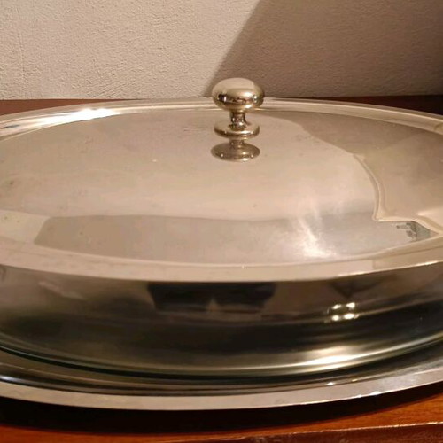 Oval glass heat-resistant dish with lid and tray used