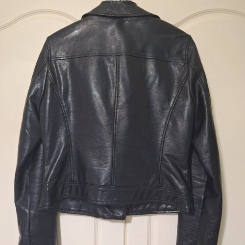 Only black biker jacket made of faux leather with silver details used