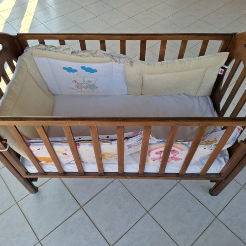 Wooden Baby Crib with Wheels and Protective Bumper, Walnut Color