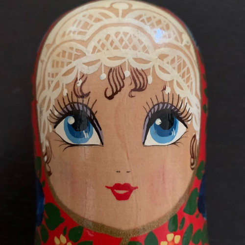 Old handmade wooden doll used with painted decoration