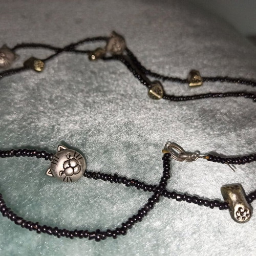 Long necklace with cat faces and paw charms like new