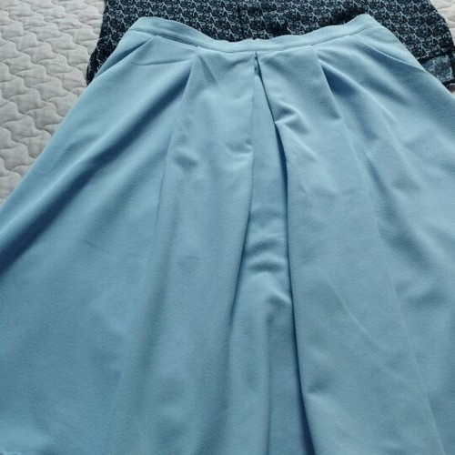 Set like new with blue knee-length skirt and semi-transparent top with ruffles