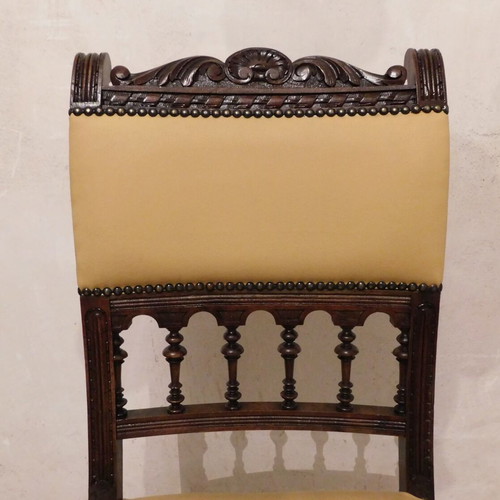 Pair of carved wooden chairs with leather seat like new, about 100 years old