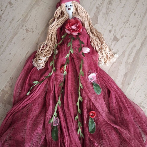 Handmade decorative wall doll with ceramic face and burgundy dress