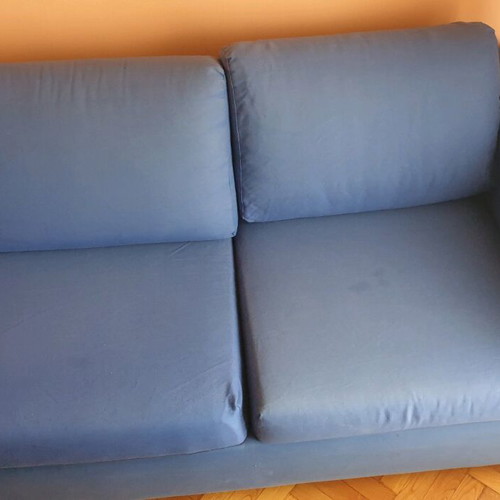 Two-seater sofa used without two back cushions