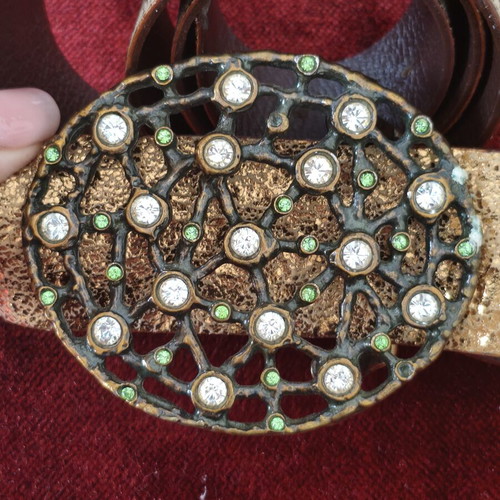 Wide gold belt used with decorative buckle and rhinestones