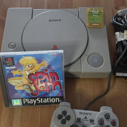 Sony PlayStation 1 console used with memory card, controller, and game