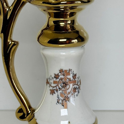 Ceramic candlestick with gold details and floral cross design