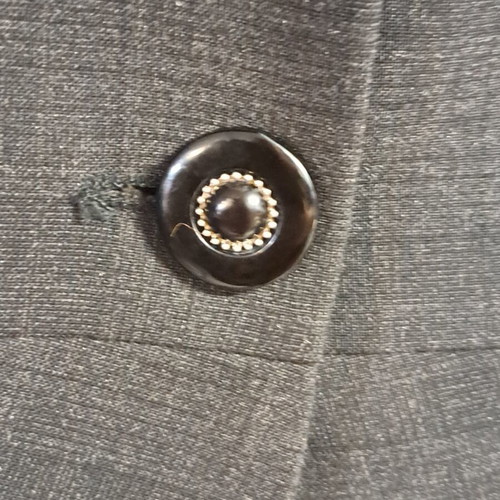 Women's black jacket with unique collar design and metallic detail