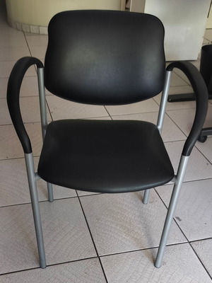 Black visitor chair with metal frame used