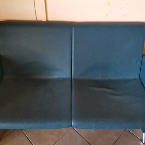 Two-seater sofa used with metal legs blue leatherette