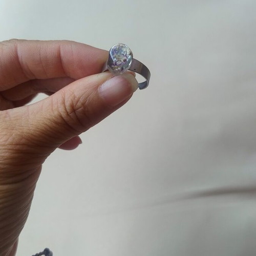Floral ring handmade with lilac flowers in epoxy resin