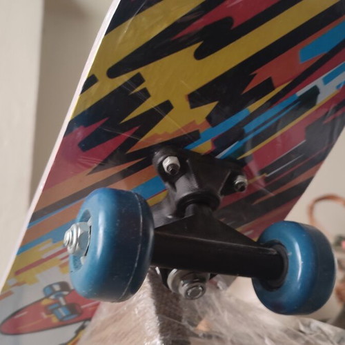 Children's skateboard with colorful comic design, sealed
