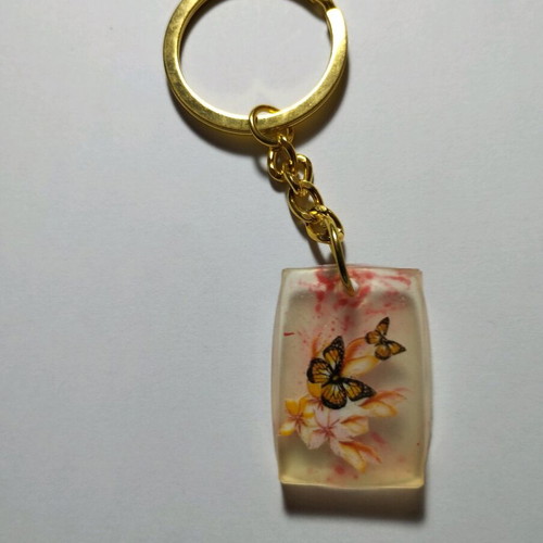 Handmade butterfly keychain from resin like new, white multicolor