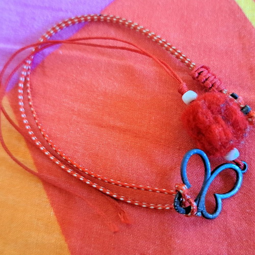 Martis bracelet like new with metal butterfly red and white