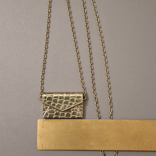 Abysse pendant bag in gold tone with chain used