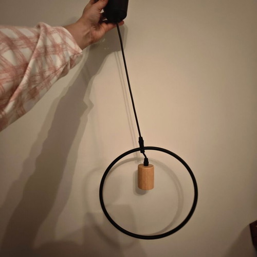 Pendant light used with black metal frame and wooden detail