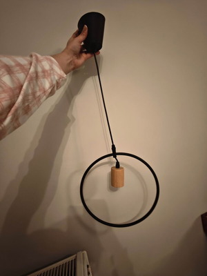 Pendant light used with black metal frame and wooden detail