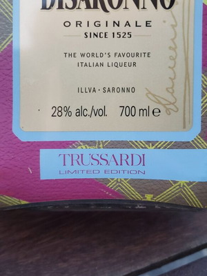 Collectible empty Amaretto bottles designed by Missoni and Trussardi, used