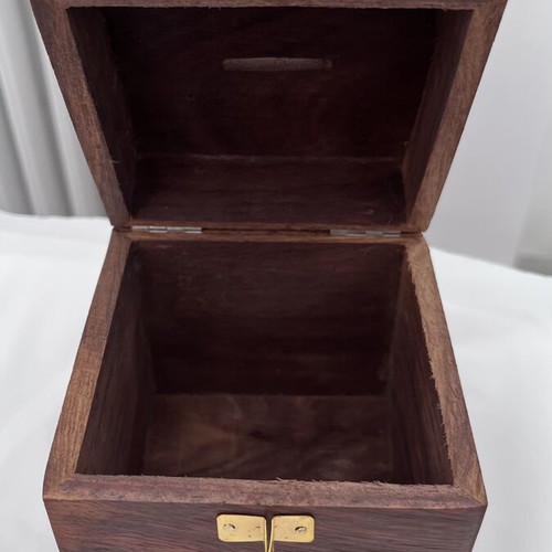 Wooden coin box with brass clip and carved design