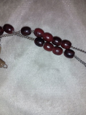 Worry beads used with red-brown plastic beads on metal chain