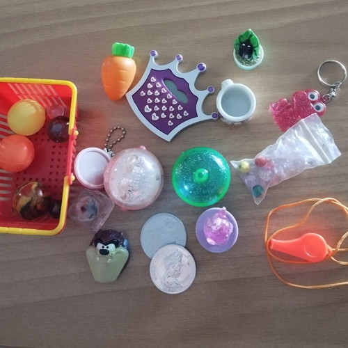 Various toys like new, including keychains, balls, marbles, beads, whistle