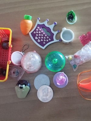 Various toys like new, including keychains, balls, marbles, beads, whistle
