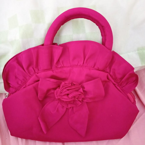 Pink handbag with zipper and handles