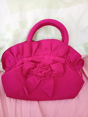 Pink handbag with zipper and handles