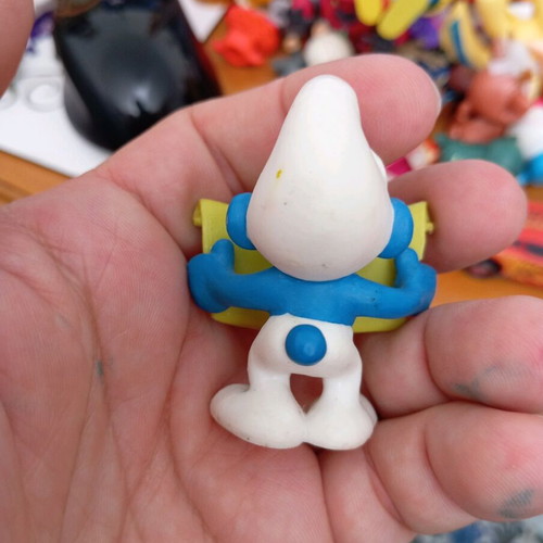 Smurf figure used reading a book