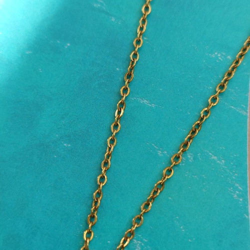 Steel necklace like new with blue mataki stone gold color