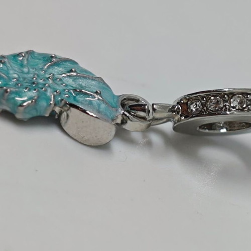 Silver charm with blue enamel Nautilus like new
