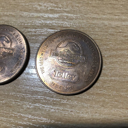 Jurassic World Tetley Velociraptor and Pteranodon coins, 38mm