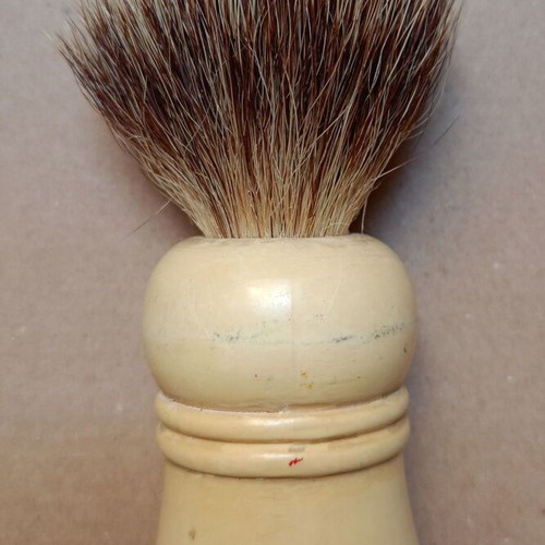 Two shaving brushes, one says it is made in West Germany.
