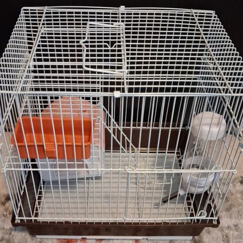 Hamster cage like new with two doors, house, feeder, and water bottle