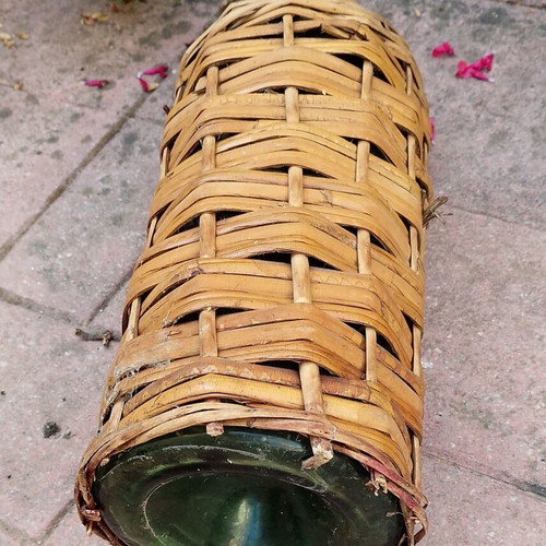 Vintage wicker wrapped demijohn with corncob stopper, used