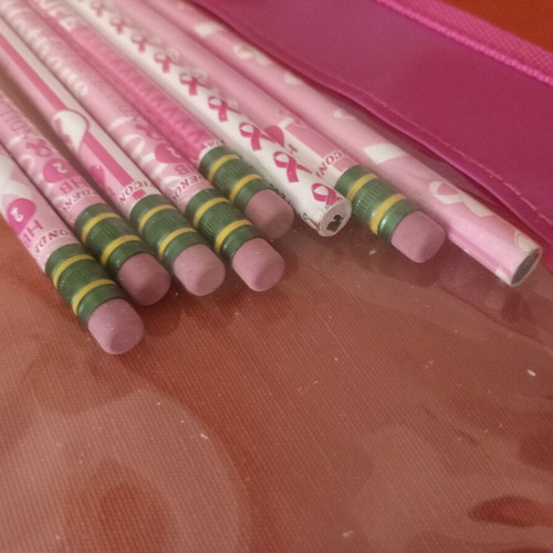 Transparent pink pencil case with used breast cancer awareness pencils