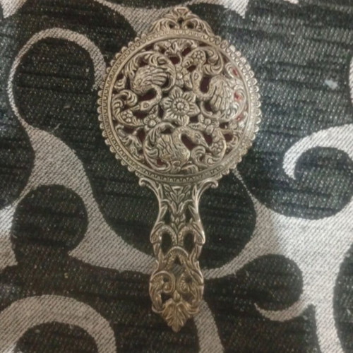Vintage hand mirror with crack