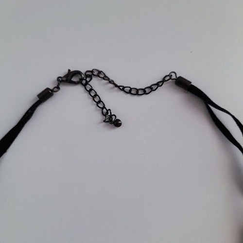 Black metal cross necklace like new with shiny stones on velvet ribbon