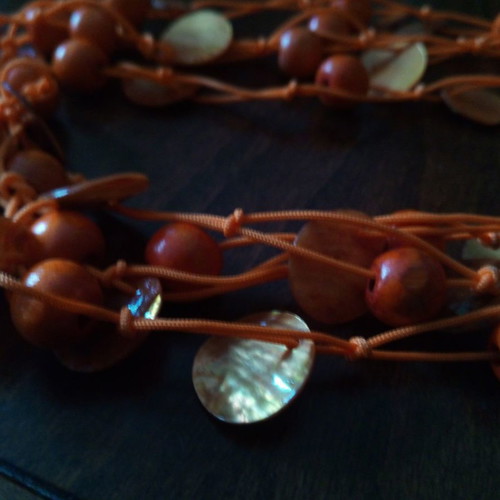 Alternative summer necklace used with wooden beads and orange mother of pearl