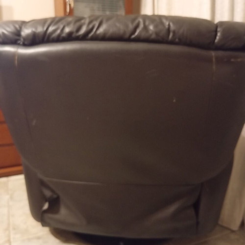 Leather recliner armchair used with wear on seat and footrest