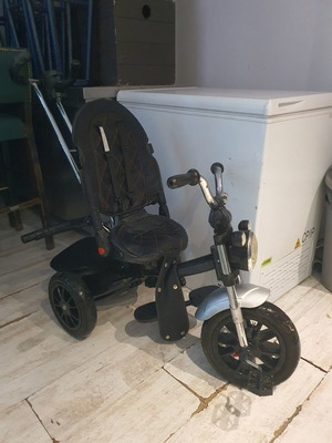Tricycle used with some fabric wear and missing parts
