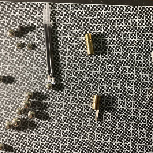 Gold Fidget Pen used with magnetic parts and two ink refills