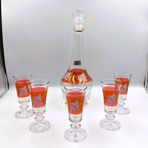 Italian glass decanter with glasses used, red with gold details
