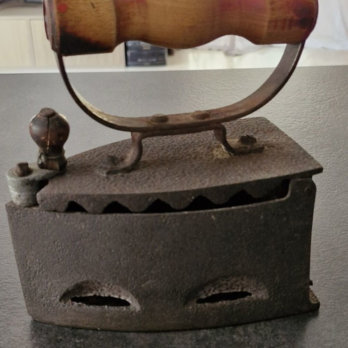 Vintage coal iron used with wooden handle and patina