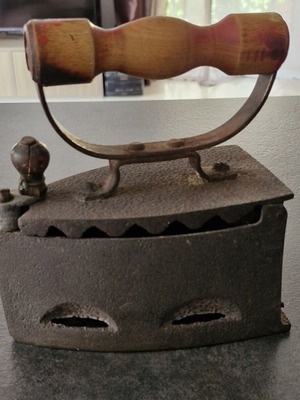 Vintage coal iron used with wooden handle and patina