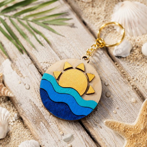 Handmade wooden summer keychain with laser cut sun and waves design